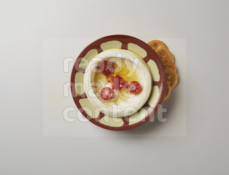 Lebnah garnished with Cherry tomato in a traditional plate on a white background