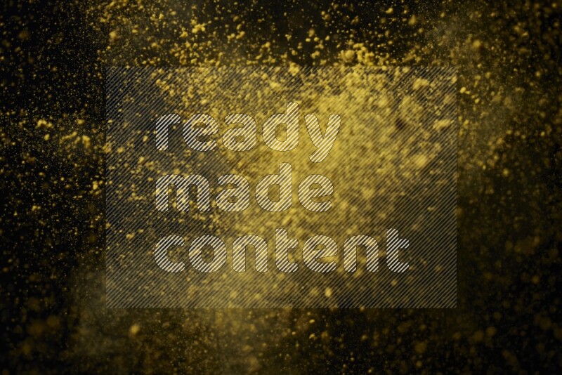 Yellow powder explosion on black background