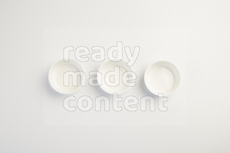 white ceramic round sauce dish on white countertop