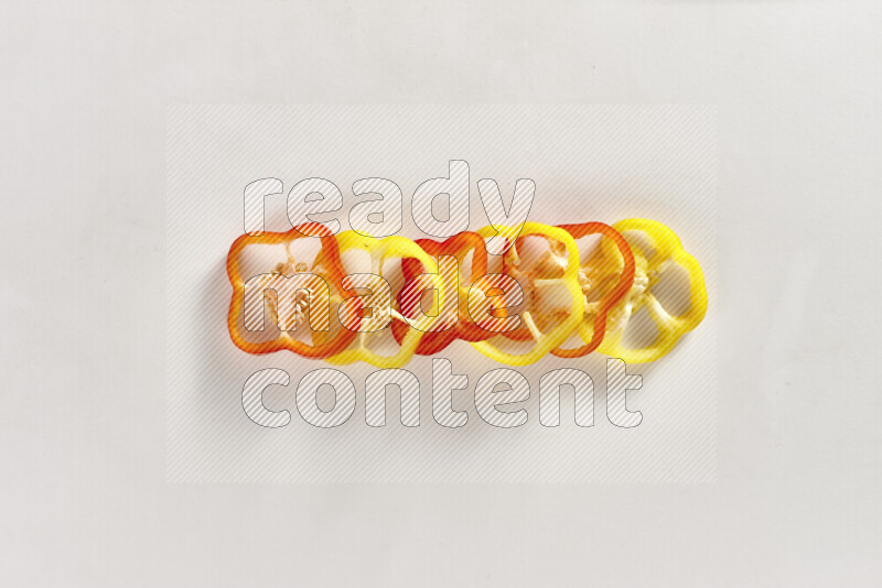 Assorted bell pepper slices on white background