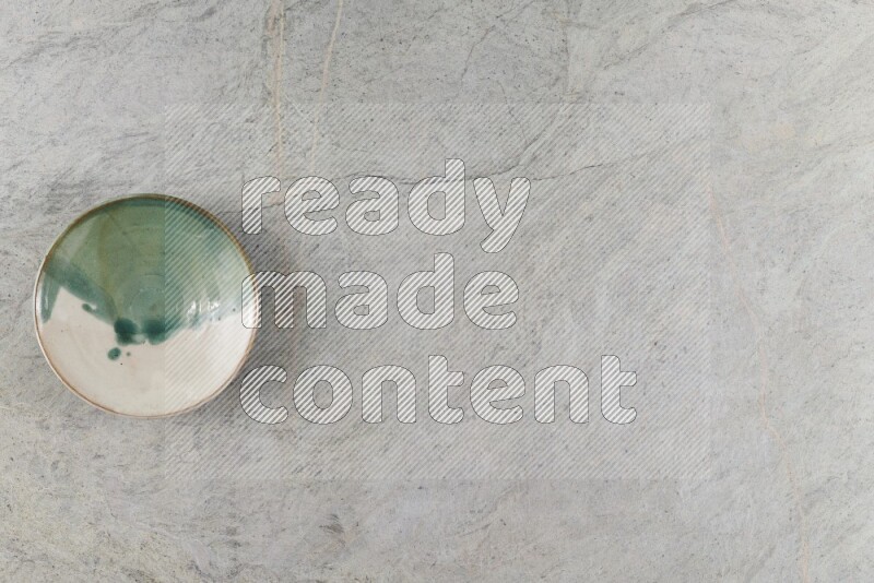 A multicolored pottery Bowl on grey marble background