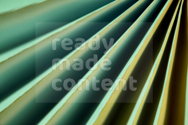 An image presenting an abstract paper pattern of lines in green and gold tones
