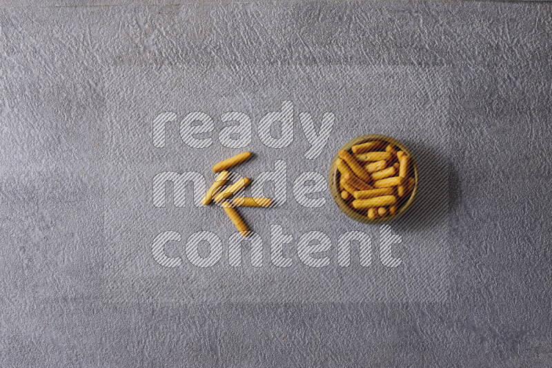Assorted snacks in pottery bowls on grey background