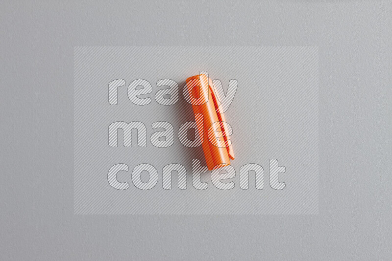 A close-up showing a single colored pen cap on grey background