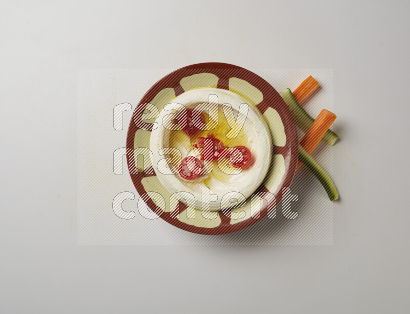 Lebnah garnished with Cherry tomato in a traditional plate on a white background