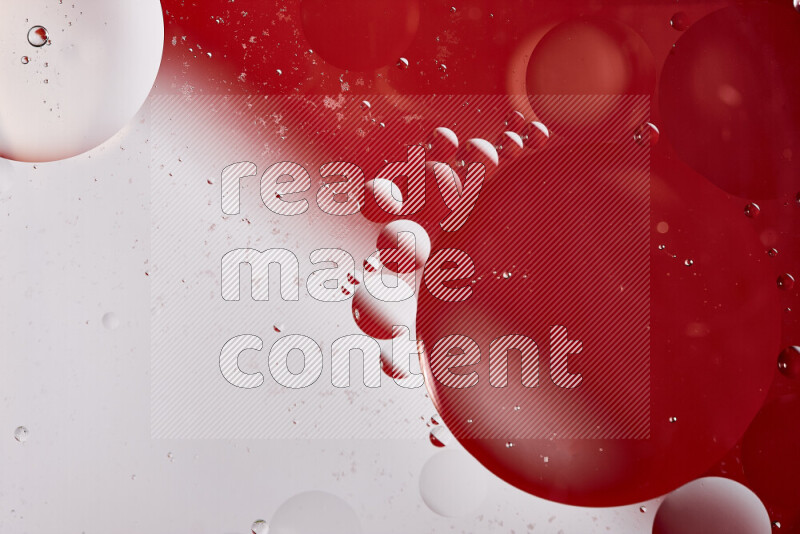 Close-ups of abstract oil bubbles on water surface in shades of white and red