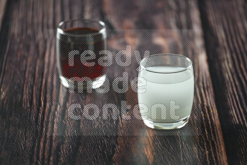 Cold drinks in a glass cup such as water, tamarind, qamar eldin, sobia, milk and hibiscus on wooden background