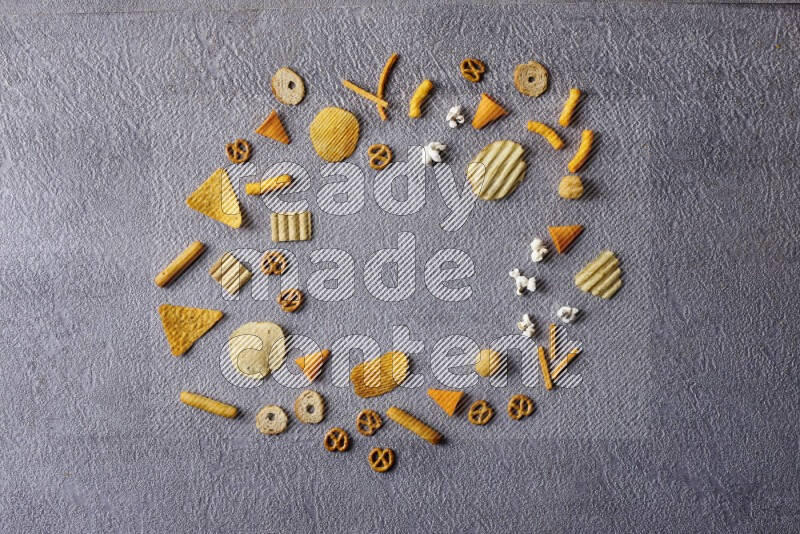 Assorted snacks in pottery bowls on grey background