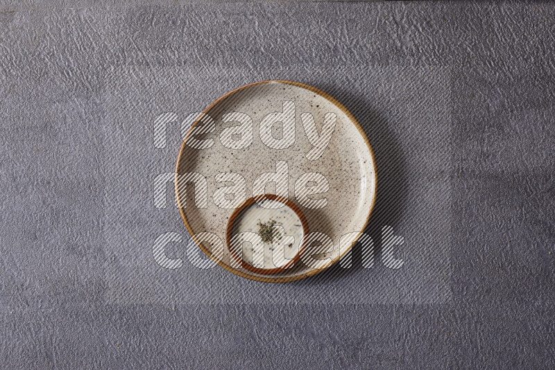Assorted snacks in pottery bowls on grey background