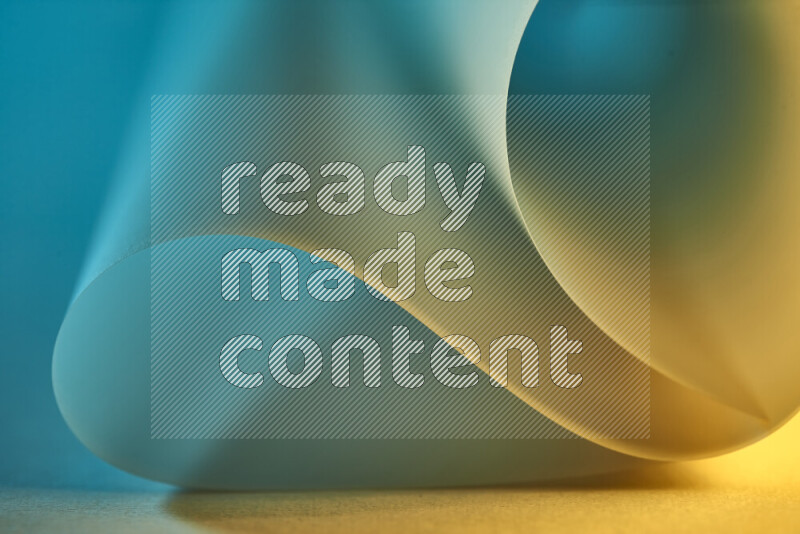 An abstract art piece displaying smooth curves in blue and gold gradients created by colored light