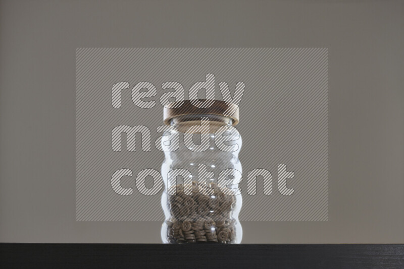 Buttons in a glass jar on black background
