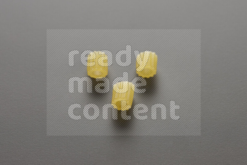 Small rings pasta on grey background
