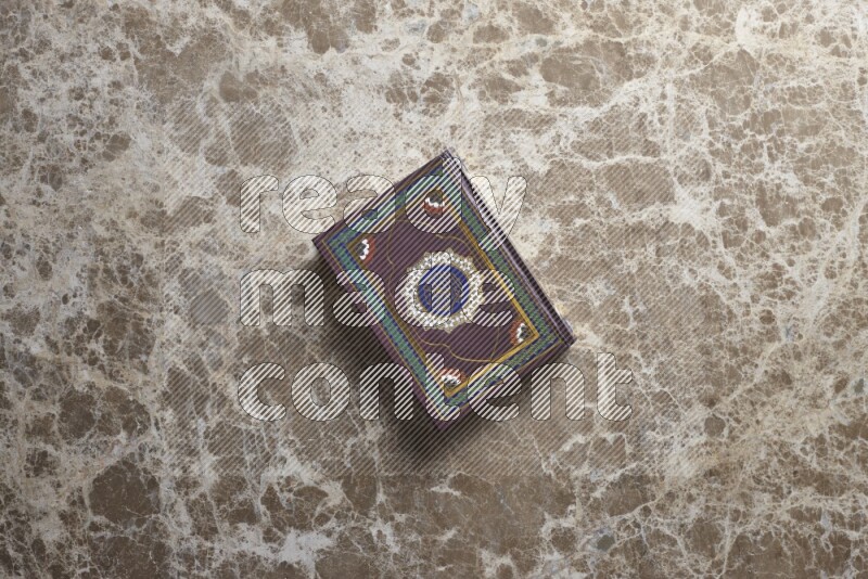 The holy Quran on beige marble background
