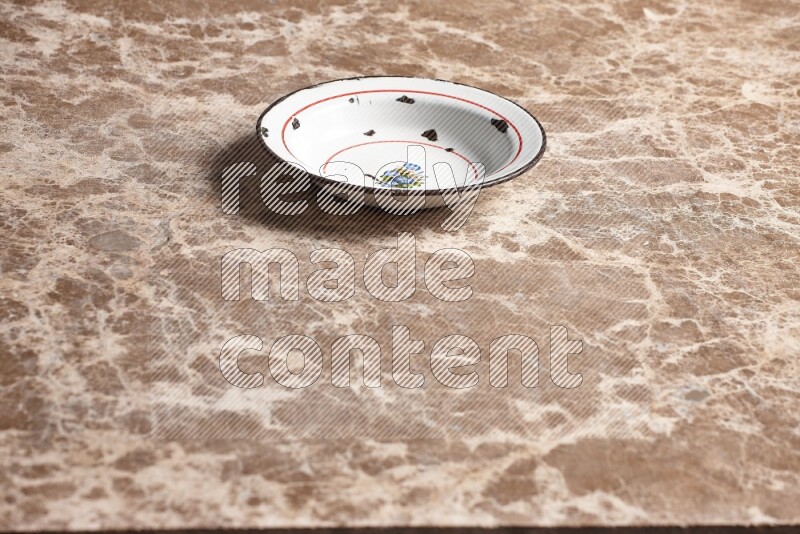A vintage metal plate on beige marble background