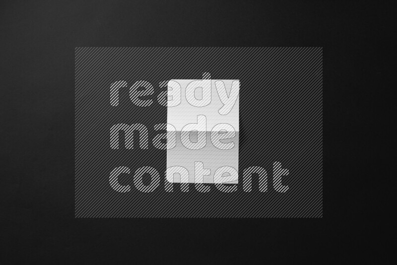 Folded notebook sheet on black background