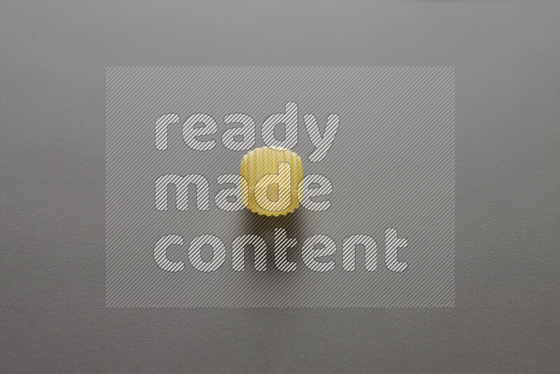 Big rings pasta on grey background