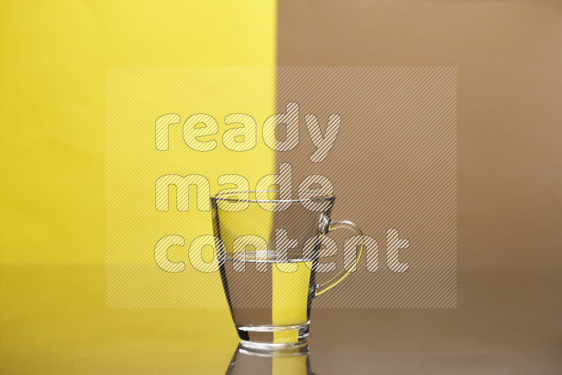 The image features a clear glassware filled with water, set against yellow and beige background