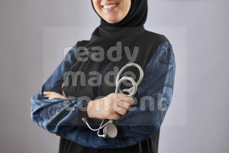 Female doctor wearing an abaya and medical attire in different positions