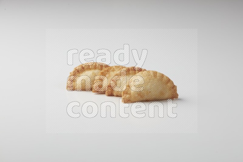 Four fried sambosas on a white background