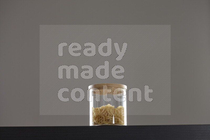 Snacks in a glass jar on black background