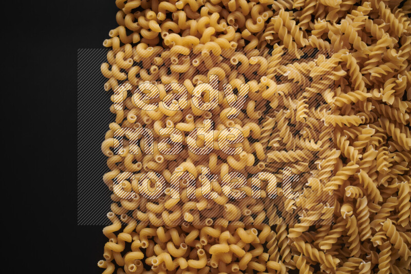 Different pasta types on black background