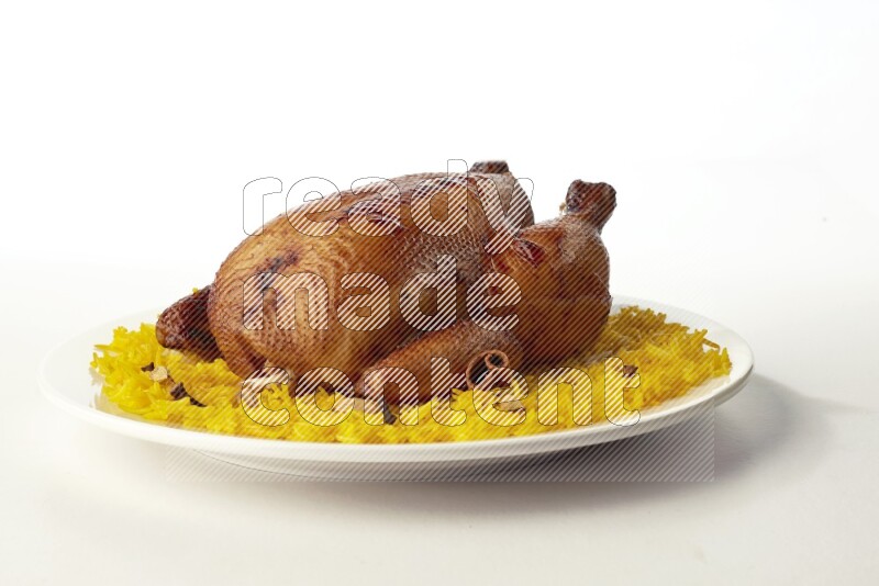 yellow  basmati Rice with  whole roasted chicken on a white rounded plate direct on white background