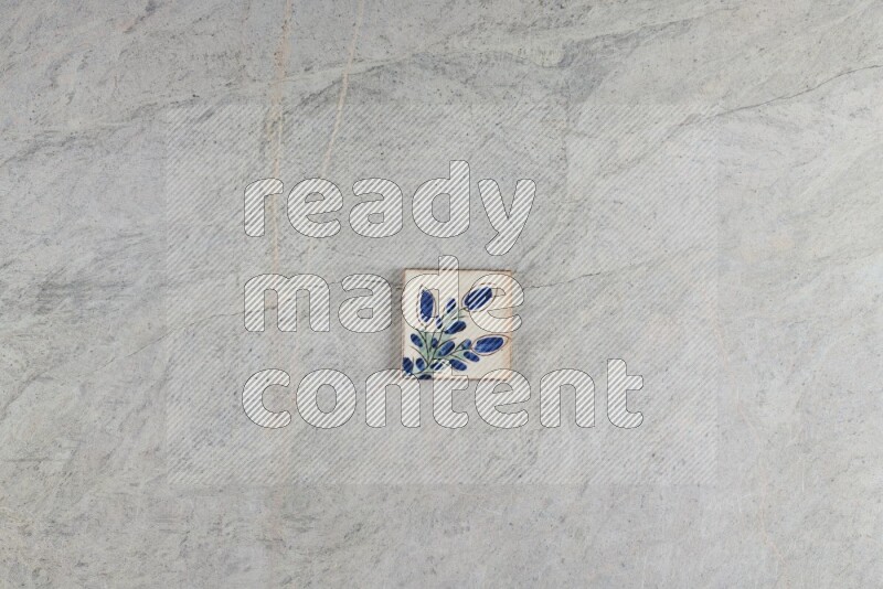 A decorative pottery coaster on grey marble background