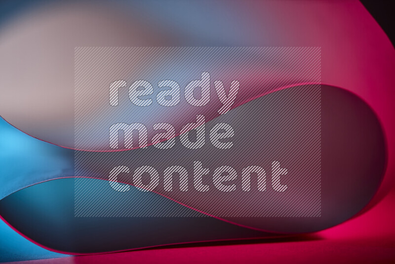 An abstract art piece displaying smooth curves in blue and red gradients created by colored light