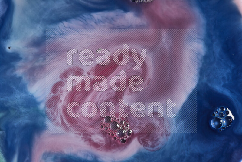 A close-up of abstract swirling patterns in blue, red and white