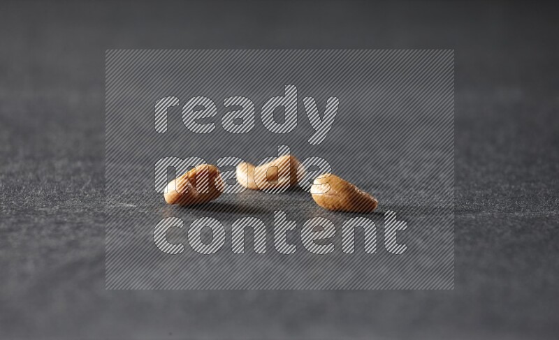 3 cashews on a black background in different angles