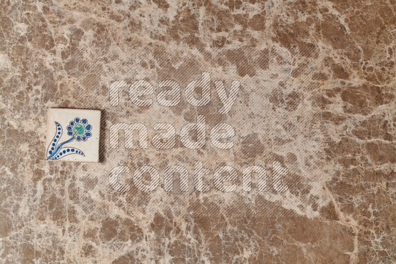 A decorative coaster on beige marble background