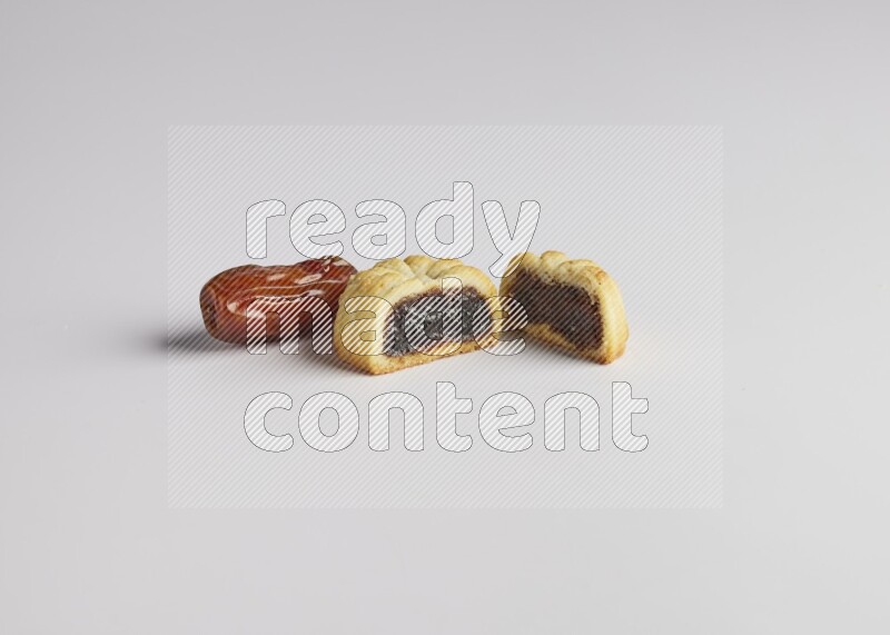 Half Maamoul filled with date with Date on the side direct on white background
