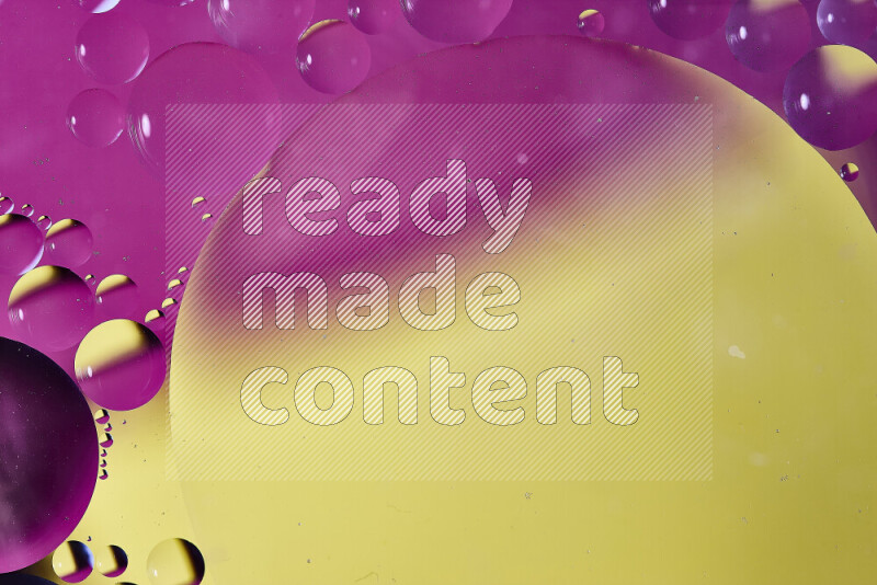 Close-ups of abstract oil bubbles on water surface in shades of yellow and pink