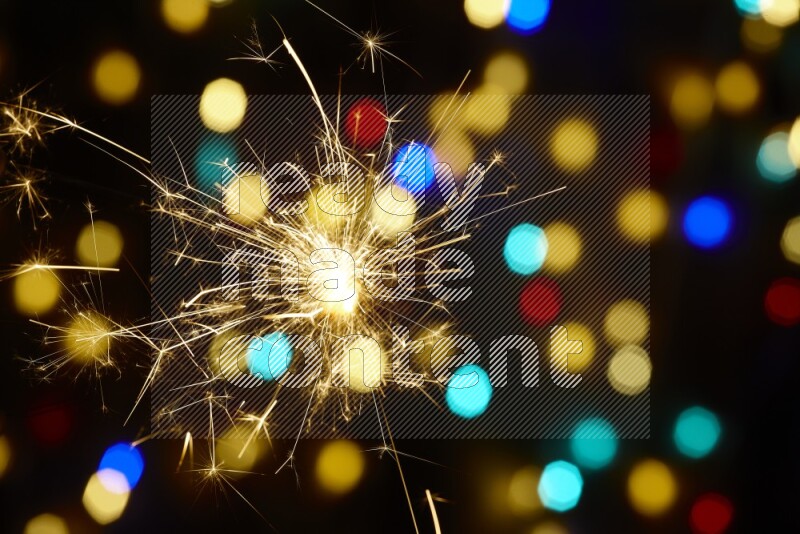 Sparkler candles with multicolored light bokeh background