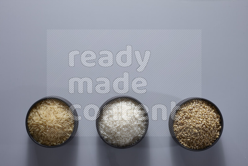 Legumes in pottery bowls on light grey background