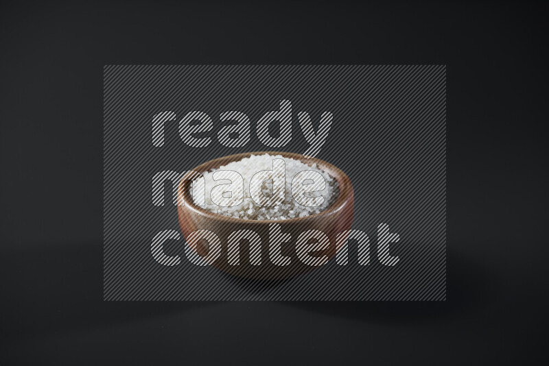 White rice in a wooden bowl on grey background