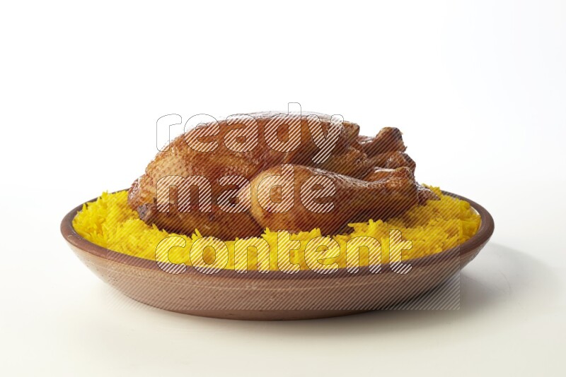 yellow basmati Rice with whole roasted chicken  on a pottery plate  direct  on white background