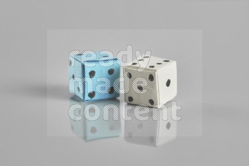 Origami dice on grey background