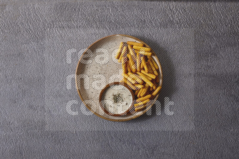 Assorted snacks in pottery bowls on grey background