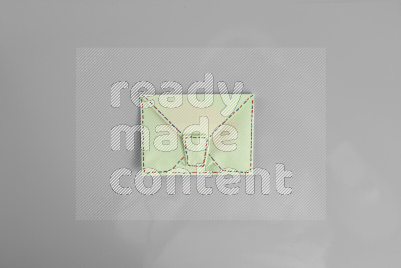 Origami envelope on grey background