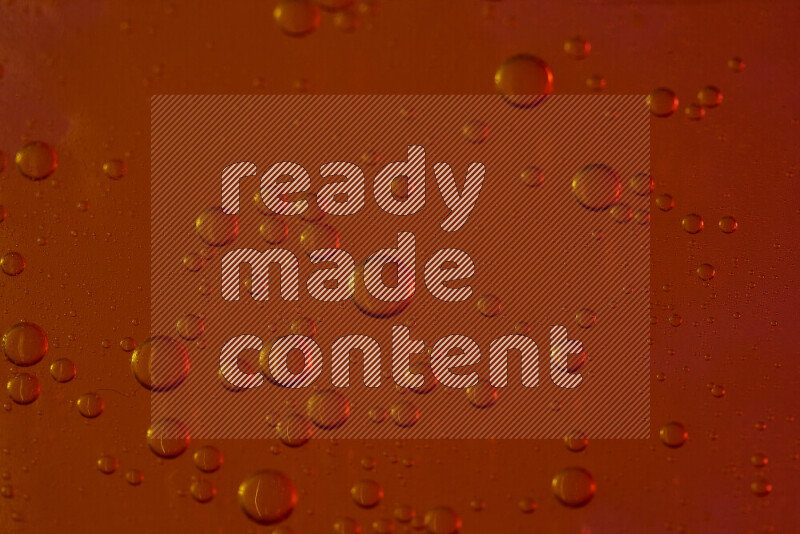 Close-ups of abstract water drops on oil Surface on red background