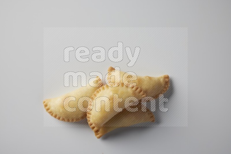 Four fried sambosa from a top angle on a white background