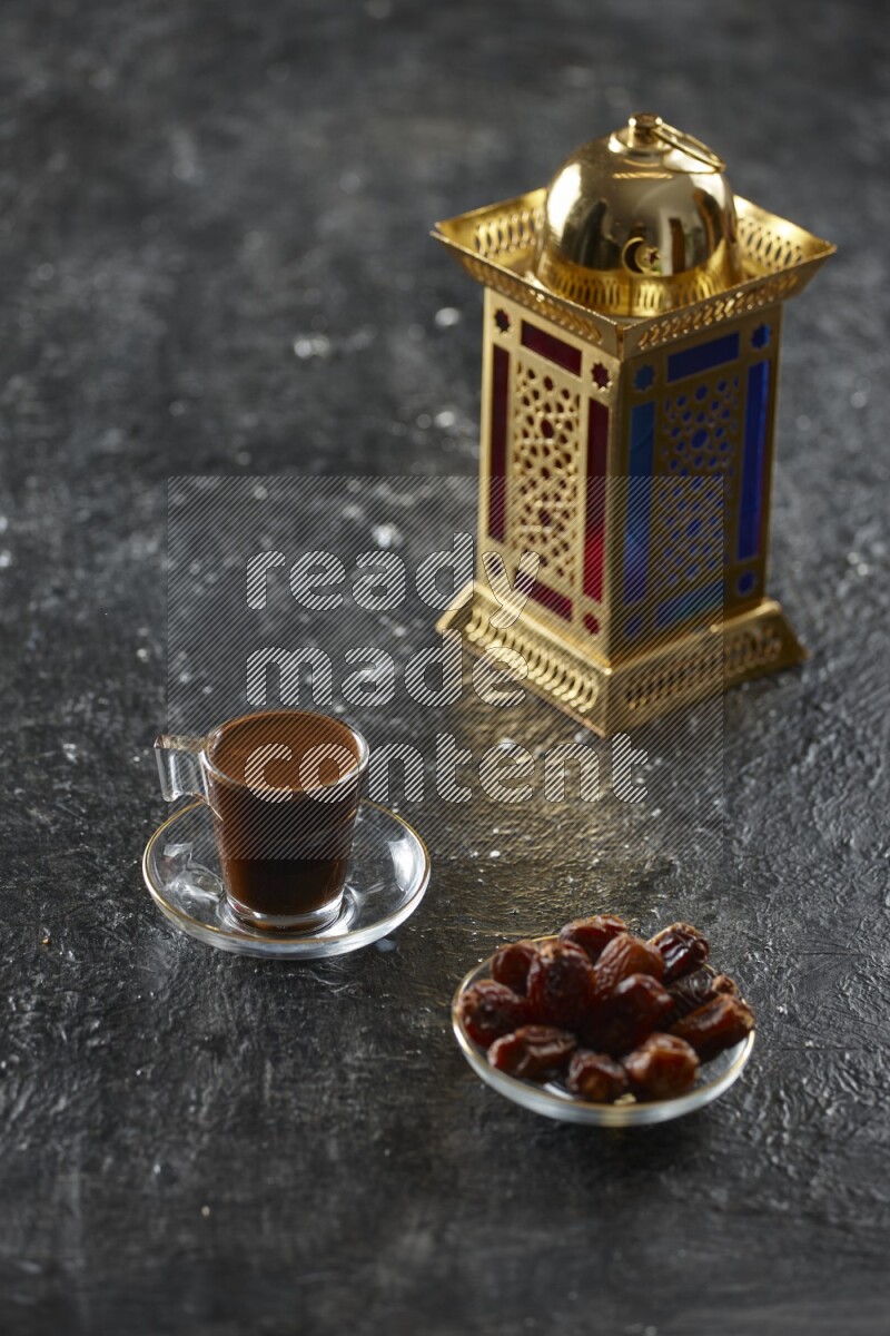 A golden lantern with different drinks, dates, nuts, prayer beads and quran on textured black background