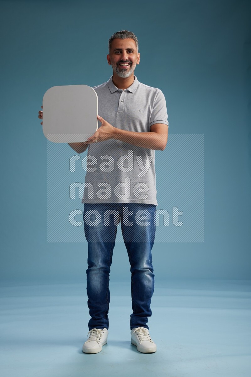 Man Standing holding social media sign on blue background