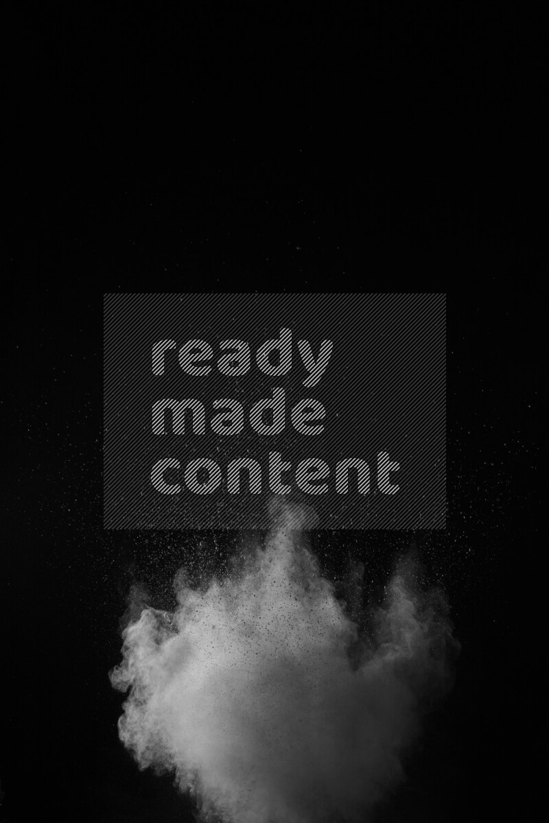A side view of white powder explosion on black background