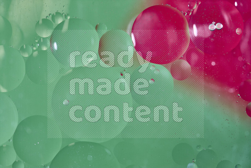 Close-ups of abstract oil bubbles on water surface in shades of green and red