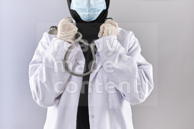 Female doctor wearing an abaya and medical attire in different positions