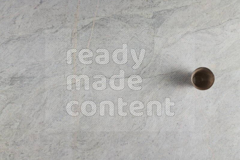 A multicolored pottery Cup on grey marble background