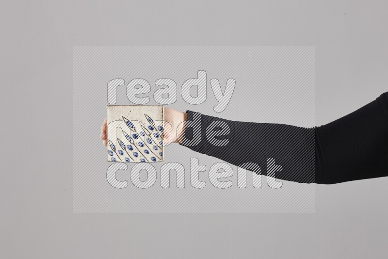 A woman in black abaya holding different pottery essentials in different positions