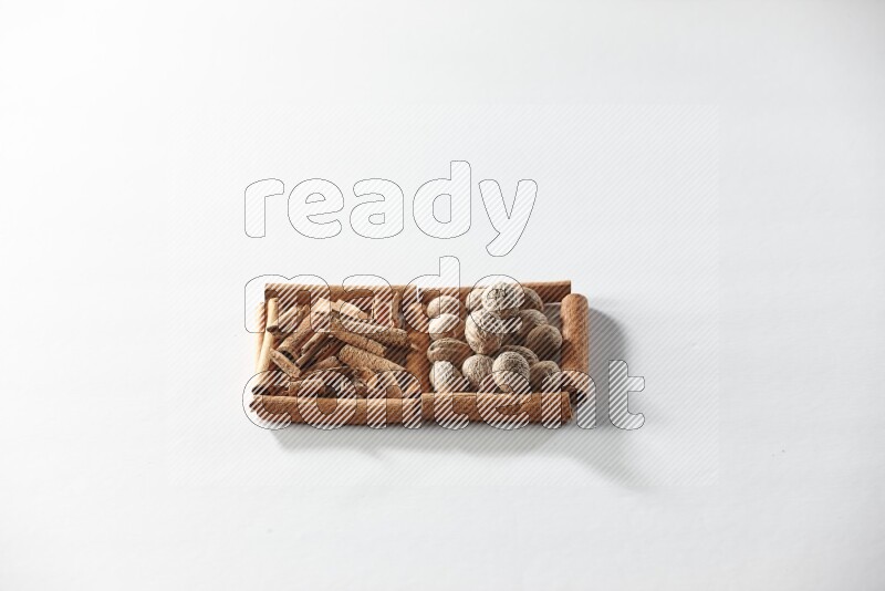 2 squares of cinnamon sticks full of cinnamon and nutmeg on white flooring